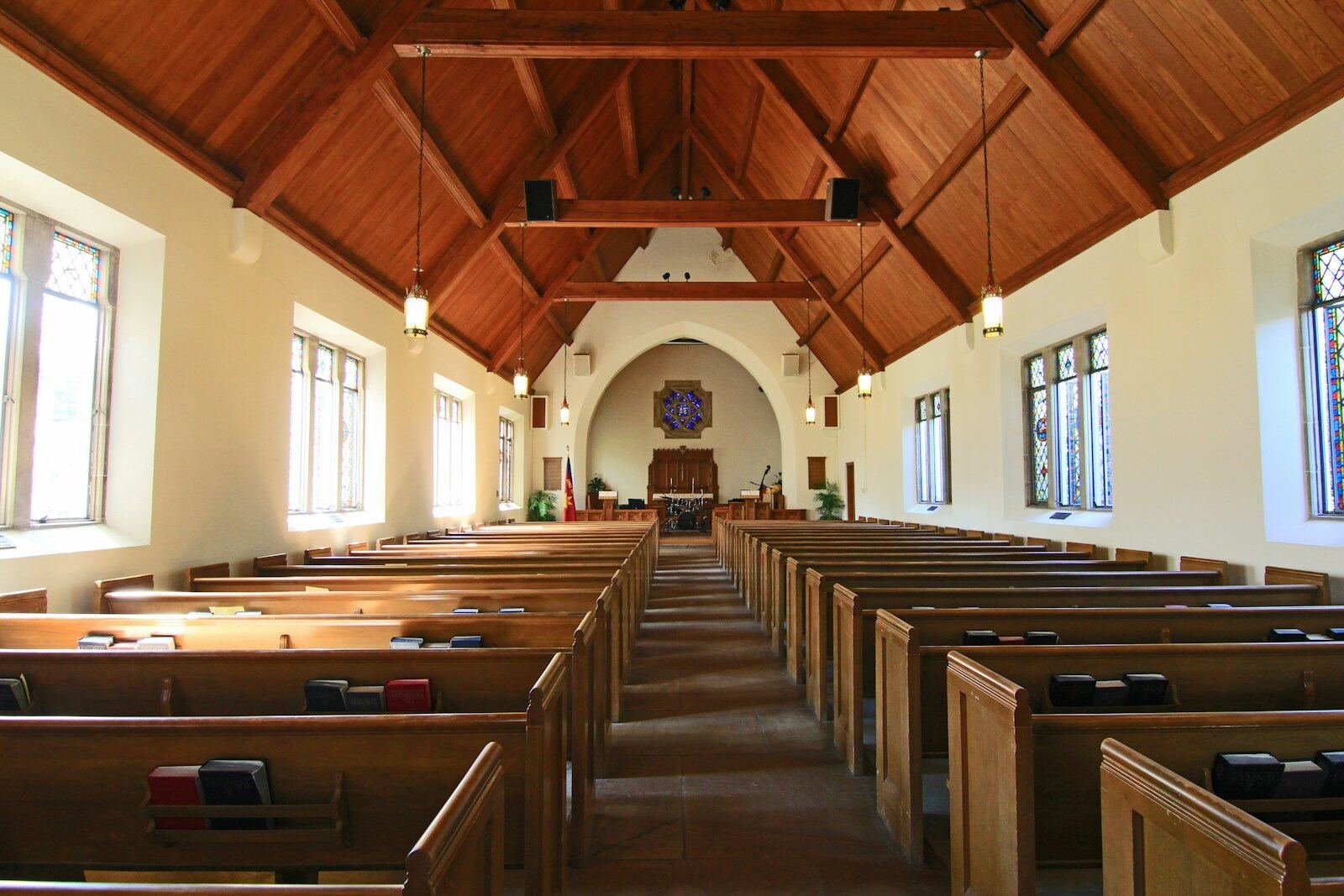 The quiet interior of a church with wooden pews