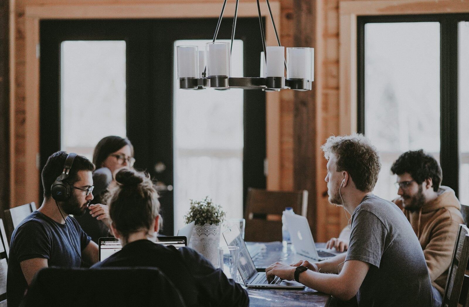 A small team working together at laptops in a bright café